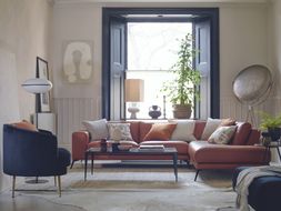 DFS Nuela open ended corner sofa in tan leather, and Enchanted accent chair and bench stool in black velvet