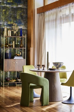 Dwell Negozio Mango Wood Shelving Unit, available at DFS Dwell Maali Cutout Velvet Dining Chair in Olive, Dwell Terzo Dining Table in Walnut, Dwell Lille dining chair in green velvet, All available at DFS